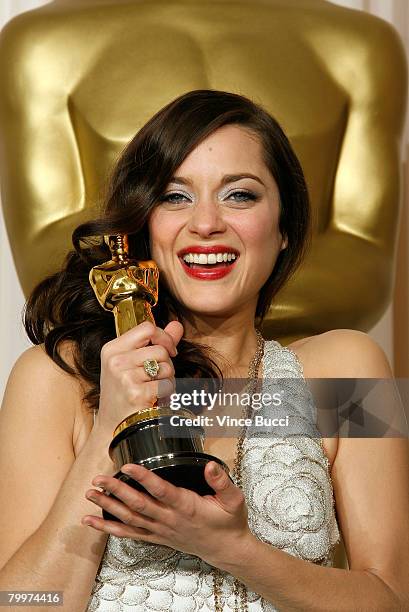 Actress Marion Cotillard, winner of the Performance By An Actress In A Leading Role award for "La Vie en Rose" poses in the press room during the...