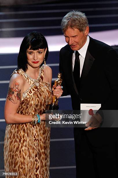 Writer Diablo Cody stands with Harrison Ford after winning the award for Best Original Screenplay for the movie "Juno" during the 80th Annual Academy...