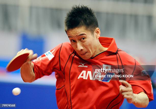 Japan's Yoshida Kaii returns a shot against France's Lebersson Emmanuel during the men' s preliminaries of the World Team Table Tennis Championship...