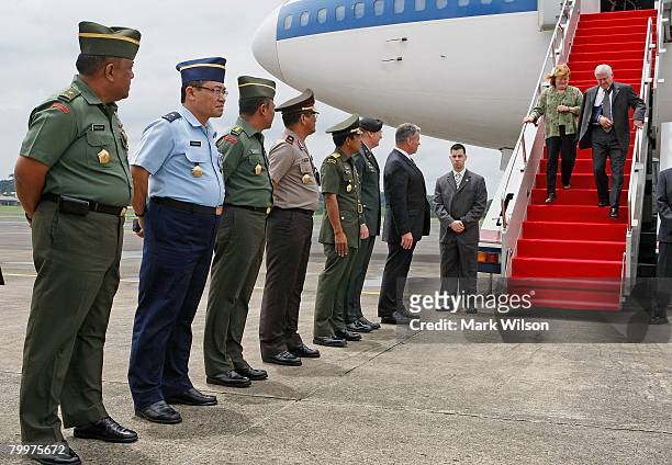 Members of the Indonesian military stand in line to greet U.S. Secretary of Defense Robert Gates as he walks off his airplane with his wife Becky ,...
