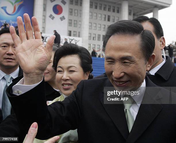 South Korea's new President Lee Myung-bak and his wife Kim Yoon-ok wave as they leave parliament in Seoul on February 25, 2008. Former businessman...