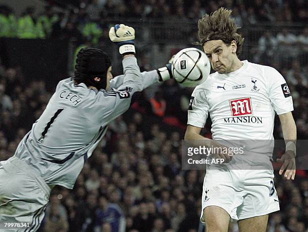 Tottenham Hotspur's English footballer Jonathan Woodgate scores past Chelsea goalkeeper Petr Cech in extra time during the Carling Cup Final match at...
