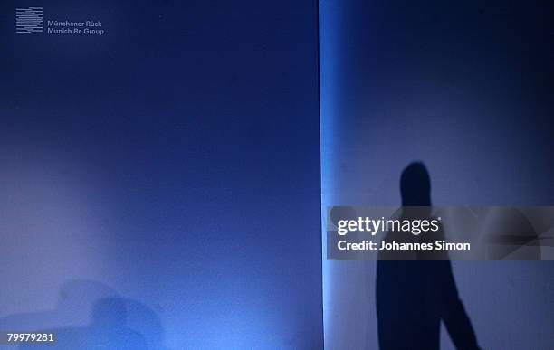 The shadow of Nikolaus von Bomhard, CEO of the Munich Re Group, is seen during the announcement of the results 2007 on February 25, 2008 in Munich,...