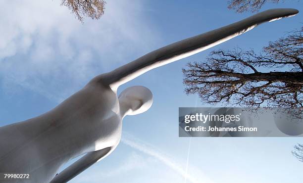 The "Walking Man" of U.S.-artist Jonathan Borofsky, is seen in front of Munich Re insurance group headquarter during the announcement of the results...