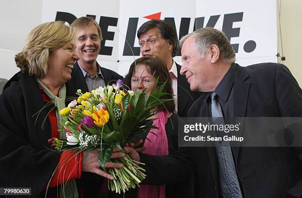 German left-wing party Die Linke co-Chairman Lothar Bisky hands flowers to Die Linke lead candidate in yesterday's Hamburg state parliamentary...