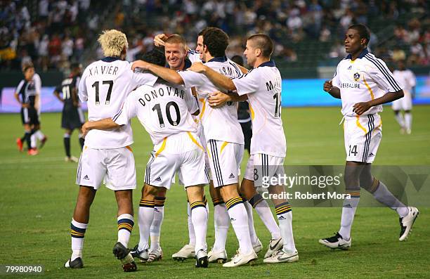 David Beckham is congratulated by Los Angeles Galaxy teammates after scoring with afree kick during the MLS Superliga match between DC United and Los...