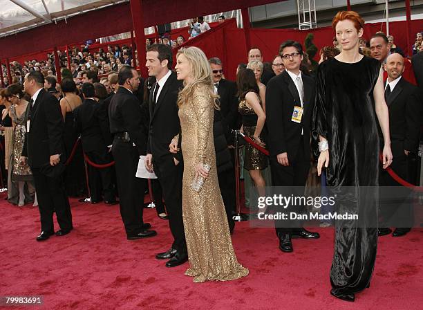 Actress Tilda Swinton poses on the red carpeet beside actress Faye Dunaway and her son Liam O'Neill as they arrvie to attend The 80th Annual Academy...