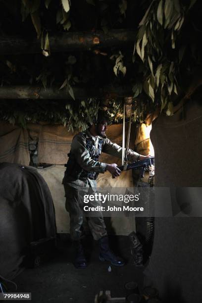 Pakistani Army soldier mans a machine gun in a bunker on a strategic mountain top February 25, 2008 in Uchrai Sar, northwestern Pakistan. The army...