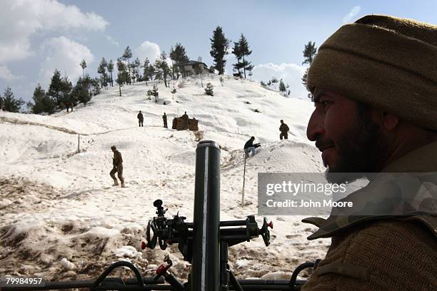 Pakistani Army soldier stands by a mortar tube on a strategic mountain top February 25, 2008 in Shangla, northwestern Pakistan. The army has been...