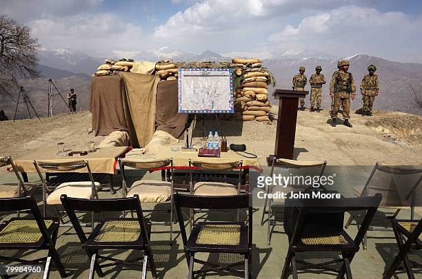 Pakistani Army soldiers stand guard ahead of a military briefing on a strategic mountain top February 25, 2008 in Uchrai Sar, northwestern Pakistan....
