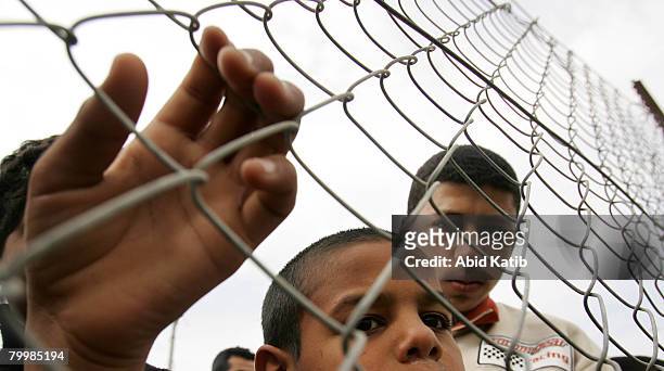 Palestinians attend a human chain protest starting at the southern Rafah border with Egypt and running to the Erez checkpoint at the northern border...