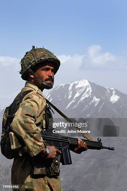 Pakistani Army soldier stands guard on a strategic mountain top February 25, 2008 in Uchrai Sar, northwestern Pakistan. The army has been battling...