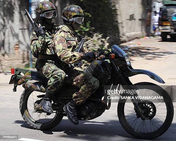 Sri Lankan police Special Task Force motorcycle unit commandos patrol a street outside a school in Colombo on February 22, 2008 as part of tightened...