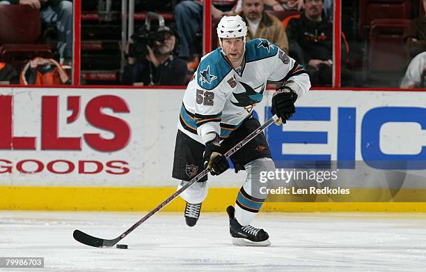 Craig Rivet of the San Jose Sharks skates the puck against the Philadelphia Flyers on February 21, 2008 at the Wachovia Center in Philadelphia,...