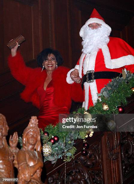 Dame Shirley Bassey and Christopher Biggins as Santa Claus attend Liz Brewer's christmas party for her good friend Dame Shirley Bassey to celebrate...