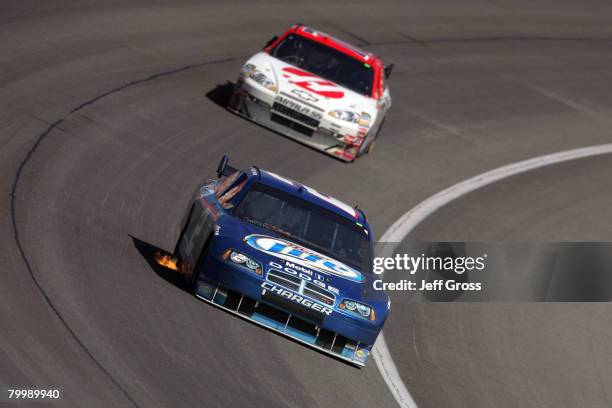 Kurt Busch, driver of the Miller Lite Dodge, races in front of Jeremy Mayfield, driver of the Haas Automation Chevrolet, during the NASCAR Sprint Cup...