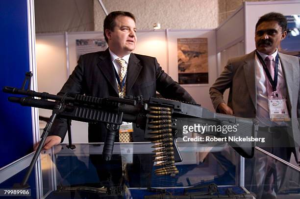 An American arms dealer explains his company's weapons conversion system for a US made M60 machine gun to an interested Indian February 18, 2008 in...