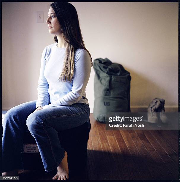 Tyra Grauer sits among her husband, Capt. John Grauer's belongings at home on August 30, 2006 in Eagle River, 10 miles outside of Anchorage, Alaska....