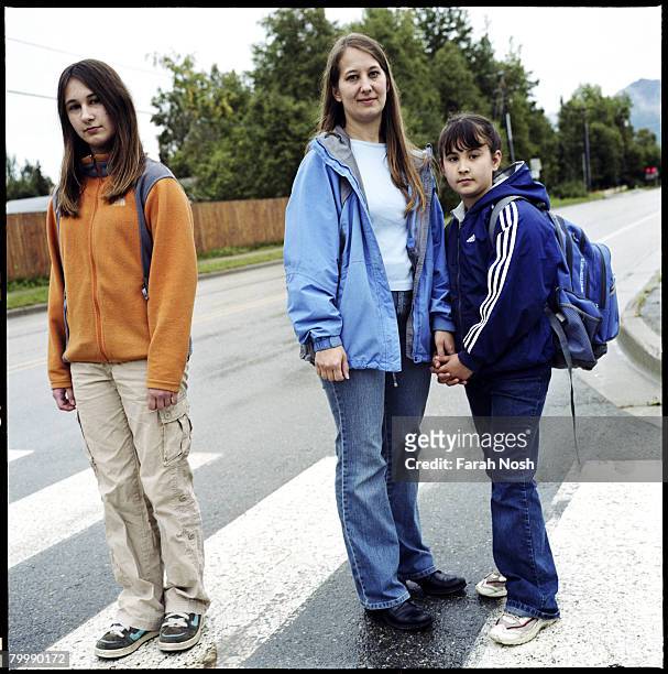 Tyra Grauer stands with her two daughters, Mileah and Morriah near their home on August 30, 2006 in Eagle River, 10 miles outside of Anchorage,...
