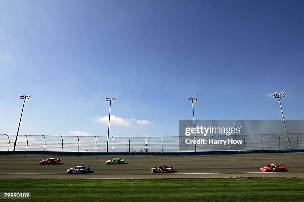 Carl Edwards, driver of the Dish Network Ford, leads Bobby Labonte, driver of the Cheerios/Hamburger Helper Dodge, during the NASCAR Sprint Cup...