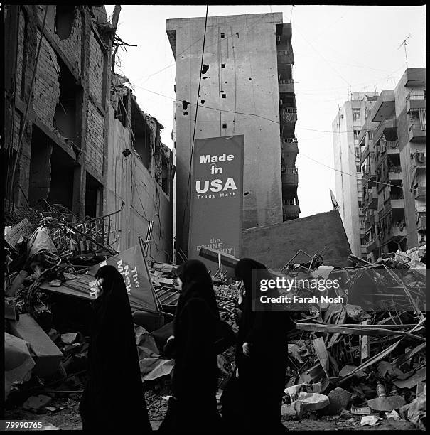 Three Muslim women walk among the rubble on August 31, 2006 in Dahiya, the southern suburb district of Beirut, Lebanon. The 2006 conflict between...
