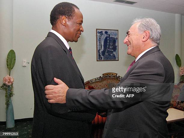 International Monetary Fund 's Managing Director Dominique Strauss-Kahn shakes hands with President Blaise Compaore of Burkina Faso at the Ouaga...