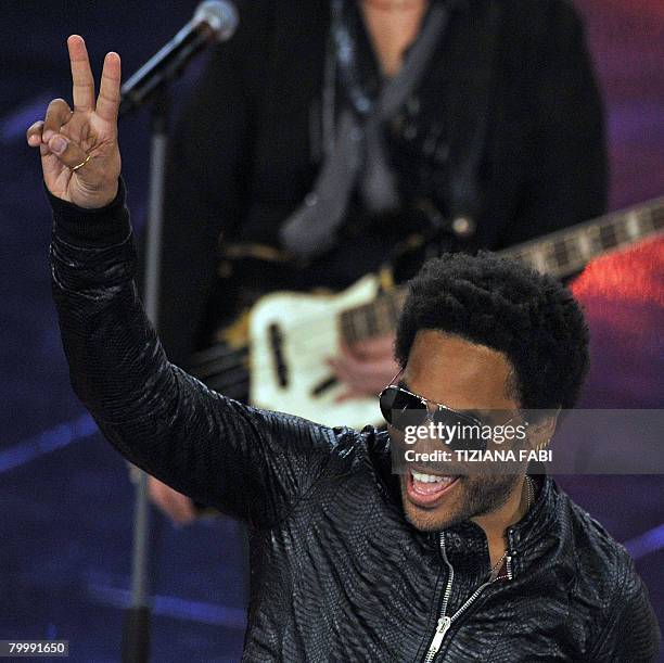 Singer Lenny Kravitz waves to the audience after performing on the stage of the Ariston Theatre in Sanremo, during the 58th Italian Music Festival on...