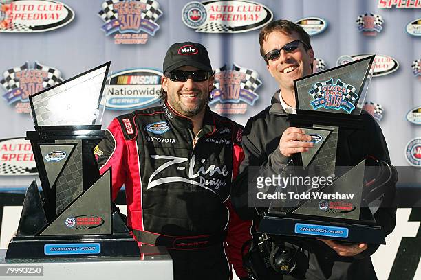 Tony Stewart, driver of the Z-Line Designs Toyota, celebrates with car owner J.D. Gibbs, after winning the NASCAR Nationwide Series Stater Brothers...