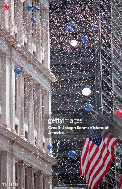 confetti and balloons at parade - parade balloon stock pictures, royalty-free photos & images