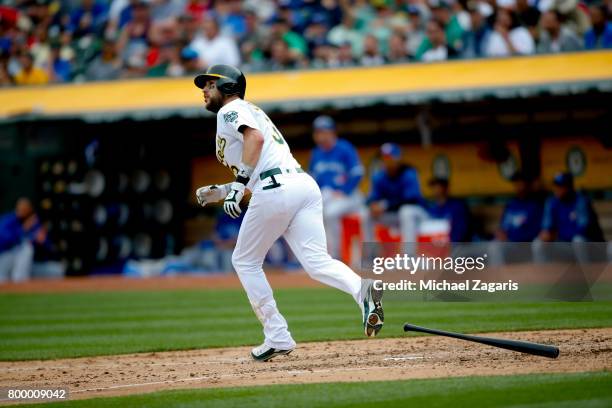 Trevor Plouffe of the Oakland Athletics hits a home run during the game against the Toronto Blue Jays at the Oakland Alameda Coliseum on June 7, 2017...