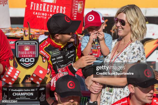 Kyle Larson , driver of the Cars 3/Target Chevrolet, tickles his son during the awards ceremony following the conclusion of the Monster Energy Cup...