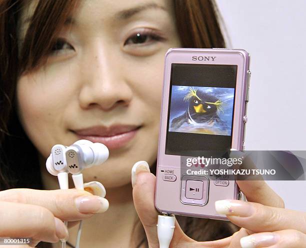 Eiko Sato employee of Sony, displays a new card sized multimedia player "Walkman NW-A829", equipped with a 16GB built-in flash memory that can store...