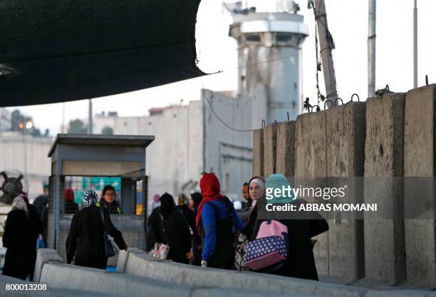 Palestinians going to pray at the al-Aqsa mosque compound in Jerusalem make their way through the Israeli Qalandia checkpoint, in the occupied West...