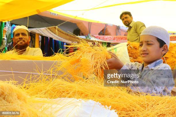 Indian Muslim boy waiting for customer to selling vermicelli at Ramganj Bazar ahead of Eid al-Fitr, during the holy month of Ramadan in...