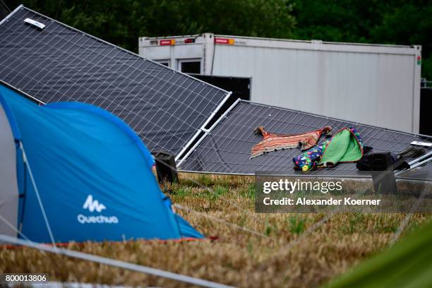 Pushed down fences are seen at the camp site of the Hurricane Festival 2017 after a night full of heavy rain and winds on June 23, 2017 in Scheessel,...