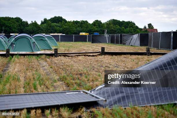 Pushed down fences are seen at the camp site of the Hurricane Festival 2017 after a night full of heavy rain and winds on June 23, 2017 in Scheessel,...