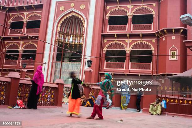 Two Muslim girls playing and enjoying there time during Ramadan month at Nakhoda masjid. Kollata,India.22.6.2017 Muslims believe that the prophet...