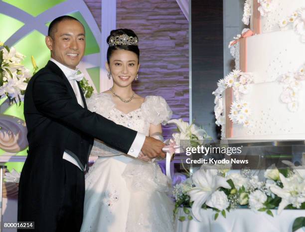 File photo taken in July 2010 shows Japanese kabuki star Ichikawa Ebizo and TV personality Mao Kobayashi during their wedding reception at a Tokyo...
