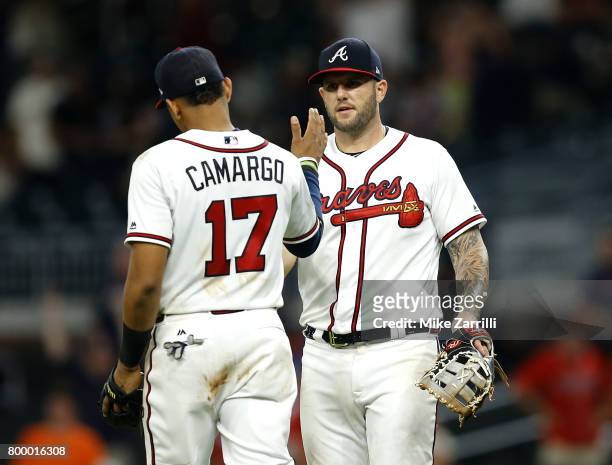 First baseman Matt Adams of the Atlanta Braves shakes hands with third baseman Johan Camargo after the game against the San Francisco Giants at...