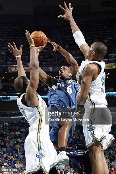Antonio Daniels of the Washington Wizards attempts to shoot past Chris Paul and David West of the New Orleans Hornets on February 25, 2008 at the New...