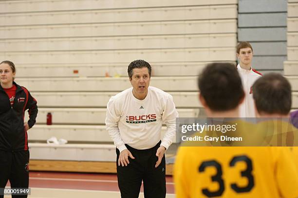 Milwaukee Bucks assistant coach Brian James teaches shooting skills during a basketball fundamentals clinic with Special Olympics athletes on...