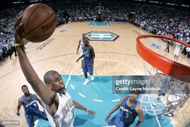 Chris Paul of the New Orleans Hornets shoots over DeShawn Stevenson and Dominic McGuire of the Washington Wizards on February 25, 2008 at the New...