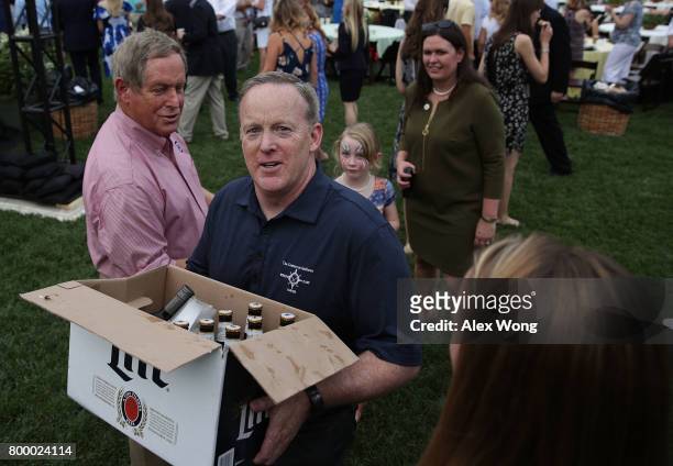 White House Press Secretary Sean Spicer delivers beer and wine to members of the media at a press riser as Principal Deputy White House Press...
