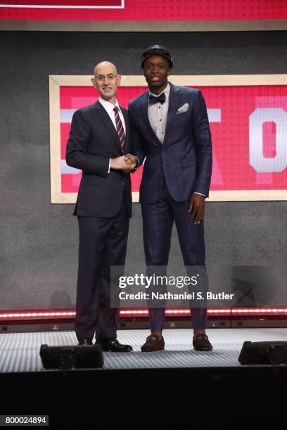 Anunoby shakes hands with NBA Commissioner Adam Silver after being selected twenty third overall by the Toronto Raptors during the 2017 NBA Draft on...