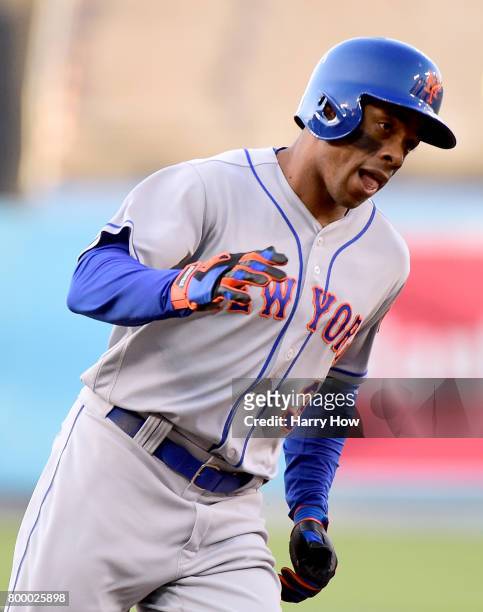 Curtis Granderson of the New York Mets reacts to his leadoff solo homerun to take a 1-0 lead over the Los Angeles Dodgers during the first inning at...