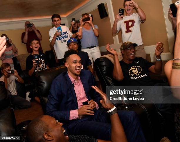 Friends and family scream out as Derrick White sits calmly in his chair after the announcement that the San Antonio Spurs had selected him 29th in...