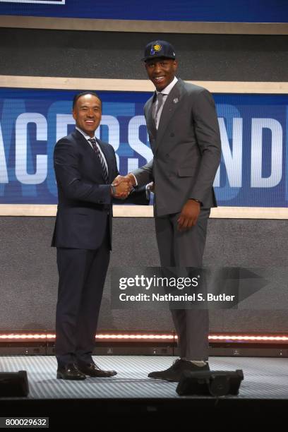 Ike Anigbogu shakes hands with Deputy Commissioner Mark Tatum after being selected number forty seventh overall by the Indiana Pacers during the 2017...