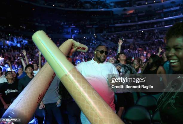 Fans watch Snoop Dogg perform onstage at night one of the 2017 BET Experience STAPLES Center Concert, sponsored by Hulu, at Staples Center on June...