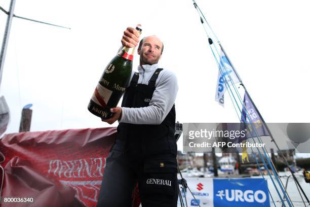 French skipper Nicolas Lunven celebrates aboard his monohull "Generali" after winning the 48th Solitaire du Figaro-Urgo solo sailing race on June 23,...
