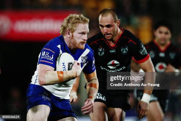 James Graham of the Bulldogs makes a run against Simon Mannering of the Warriors during the round 16 NRL match between the New Zealand Warriors and...